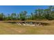 Chairs at the edge of a pond provides a relaxing and beautiful outdoor feature at 6407 213Th E St, Bradenton, FL 34211