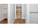 View into the primary bathroom and walk-in closet with custom shelving at 6407 213Th E St, Bradenton, FL 34211