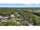 Scenic aerial view of waterfront community homes with lush greenery surrounding a tranquil river on a clear day at 6718 68Th E Ave, Bradenton, FL 34203