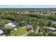 Gorgeous aerial view of a waterfront property with lush greenery and a charming home with a pool next to a tranquil river at 6718 68Th E Ave, Bradenton, FL 34203