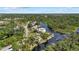 Stunning aerial view of a charming waterfront property with lush greenery, a private dock, and a tranquil river setting at 6718 68Th E Ave, Bradenton, FL 34203