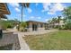 Charming backyard featuring a lovely patio, green grass, and beautiful landscaping that accents the home's exterior at 6718 68Th E Ave, Bradenton, FL 34203