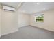 A bright, spacious bedroom with neutral carpet, a window, and climate control at 6718 68Th E Ave, Bradenton, FL 34203