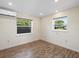 Bedroom features sleek wood floors, natural light, and fresh paint at 6718 68Th E Ave, Bradenton, FL 34203
