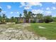 Charming home with a cozy front porch, surrounded by green foliage, creating a welcoming and serene atmosphere at 6718 68Th E Ave, Bradenton, FL 34203