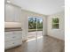 Bright kitchen featuring white cabinets, stainless steel appliances, and large sliding glass doors at 6718 68Th E Ave, Bradenton, FL 34203