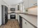 Updated kitchen featuring stainless steel appliances, sleek countertops, and white cabinets at 6718 68Th E Ave, Bradenton, FL 34203