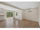 Bright, open-concept living area boasts sleek wood floors, a sliding glass door, and abundant natural light at 6718 68Th E Ave, Bradenton, FL 34203