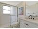 Bathroom with white vanity, marble countertop, black hardware, and shower with glass door at 7173 W Country Club N Dr # 141, Sarasota, FL 34243