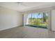 Bedroom with sliding glass doors to the lanai overlooking a well-maintained golf course at 7173 W Country Club N Dr # 141, Sarasota, FL 34243