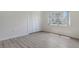 Bright bedroom with light wood-look floors, white walls, closet, and natural light at 7173 W Country Club N Dr # 141, Sarasota, FL 34243