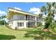 Condo building exterior with manicured lawn and tropical landscaping at 7173 W Country Club N Dr # 141, Sarasota, FL 34243