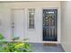Charming front door entrance with a colorful wreath, welcome mat, and vibrant green plants at 7173 W Country Club N Dr # 141, Sarasota, FL 34243