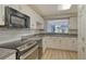 Updated kitchen featuring stainless steel appliances and crisp white cabinets at 7173 W Country Club N Dr # 141, Sarasota, FL 34243