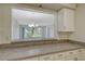 Bright kitchen featuring light countertops and a pass-through window to the living area at 7173 W Country Club N Dr # 141, Sarasota, FL 34243