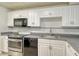 Well-lit kitchen with stainless steel appliances, sleek countertops, and ample cabinet space at 7173 W Country Club N Dr # 141, Sarasota, FL 34243