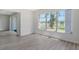 Bright living room featuring updated flooring and a large window overlooking the yard at 7173 W Country Club N Dr # 141, Sarasota, FL 34243