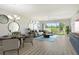 Staged living room with a view of the golf course from the large sliding glass doors at 7173 W Country Club N Dr # 141, Sarasota, FL 34243
