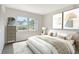 Well-lit bedroom with neutral tones, a large window, and modern art at 7173 W Country Club N Dr # 141, Sarasota, FL 34243
