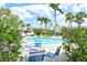 Community pool with lounge seating and lush tropical landscaping offers a refreshing and relaxing outdoor space at 7173 W Country Club N Dr # 141, Sarasota, FL 34243