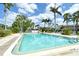 Community pool with lounge seating and lush tropical landscaping offers a refreshing and relaxing outdoor space at 7173 W Country Club N Dr # 141, Sarasota, FL 34243