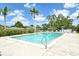Community pool with lounge seating and lush tropical landscaping offers a refreshing and relaxing outdoor space at 7173 W Country Club N Dr # 141, Sarasota, FL 34243