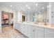 Large bathroom with a double vanity, ample storage, and access to a walk-in closet at 8592 Hidden Lagoon Rd, Sarasota, FL 34242