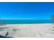 Stunning, serene view of the white sand beach and clear blue ocean at 8592 Hidden Lagoon Rd, Sarasota, FL 34242