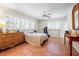 Bright bedroom features tile flooring, lots of windows, and a ceiling fan at 8592 Hidden Lagoon Rd, Sarasota, FL 34242