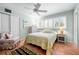 Comfortable bedroom with natural light, shutters, ceiling fan, and a calm color scheme at 8592 Hidden Lagoon Rd, Sarasota, FL 34242