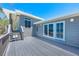 The light gray house has a gray deck with white trim and views of the beach and ocean at 8592 Hidden Lagoon Rd, Sarasota, FL 34242