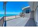 Coastal home with a spacious deck overlooking a beautiful white sand beach and turquoise water at 8592 Hidden Lagoon Rd, Sarasota, FL 34242