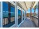 Coastal house with sliding glass doors opening onto a covered deck and great views of the beach at 8592 Hidden Lagoon Rd, Sarasota, FL 34242