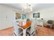 Dining area with wooden table set for six and sliding doors to the outside at 8592 Hidden Lagoon Rd, Sarasota, FL 34242