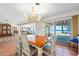 Dining area with a wooden table and a sliding door leading to the outside at 8592 Hidden Lagoon Rd, Sarasota, FL 34242