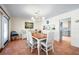 Dining room area with a wood table and seating for six under a chandelier at 8592 Hidden Lagoon Rd, Sarasota, FL 34242