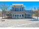 Two-story beach home featuring two decks, outdoor seating, and easy beach access at 8592 Hidden Lagoon Rd, Sarasota, FL 34242