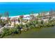 Charming beach home with a serene waterfront setting surrounded by lush greenery at 8592 Hidden Lagoon Rd, Sarasota, FL 34242