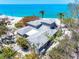 Beautiful beach house with lush tropical landscaping and expansive views of the Gulf at 8592 Hidden Lagoon Rd, Sarasota, FL 34242