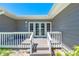 Charming porch with double doors, white railings, and a welcoming entrance with great natural light at 8592 Hidden Lagoon Rd, Sarasota, FL 34242