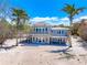 Beachfront home features a covered patio, upper deck, and inviting coastal charm at 8592 Hidden Lagoon Rd, Sarasota, FL 34242