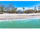 Gorgeous coastal home with panoramic ocean views, framed by palm trees and crystal-clear turquoise waters at 8592 Hidden Lagoon Rd, Sarasota, FL 34242