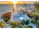 Stunning beach house at sunset with ocean views and lush foliage at 8592 Hidden Lagoon Rd, Sarasota, FL 34242