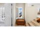 Hallway with window and shutter showing beach access; features a decorative woven chest at 8592 Hidden Lagoon Rd, Sarasota, FL 34242