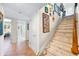 Bright hallway with tile flooring, decorative artwork, and a stair lift for convenience at 8592 Hidden Lagoon Rd, Sarasota, FL 34242