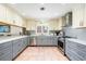 This bright and modern kitchen features stainless steel appliances, granite counters, and gray tile backsplash at 8592 Hidden Lagoon Rd, Sarasota, FL 34242