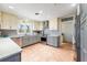 Bright kitchen features two-tone cabinetry, stainless steel appliances, and beautiful terra cotta tile flooring at 8592 Hidden Lagoon Rd, Sarasota, FL 34242