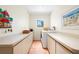 Functional laundry room with a front-load washer, dryer, and counter space at 8592 Hidden Lagoon Rd, Sarasota, FL 34242
