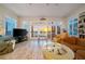 Light and airy living room with ocean view, plantation shutters, and comfortable seating arrangement at 8592 Hidden Lagoon Rd, Sarasota, FL 34242