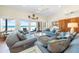 Bright living room featuring cozy seating and beautiful ocean views from large windows at 8592 Hidden Lagoon Rd, Sarasota, FL 34242